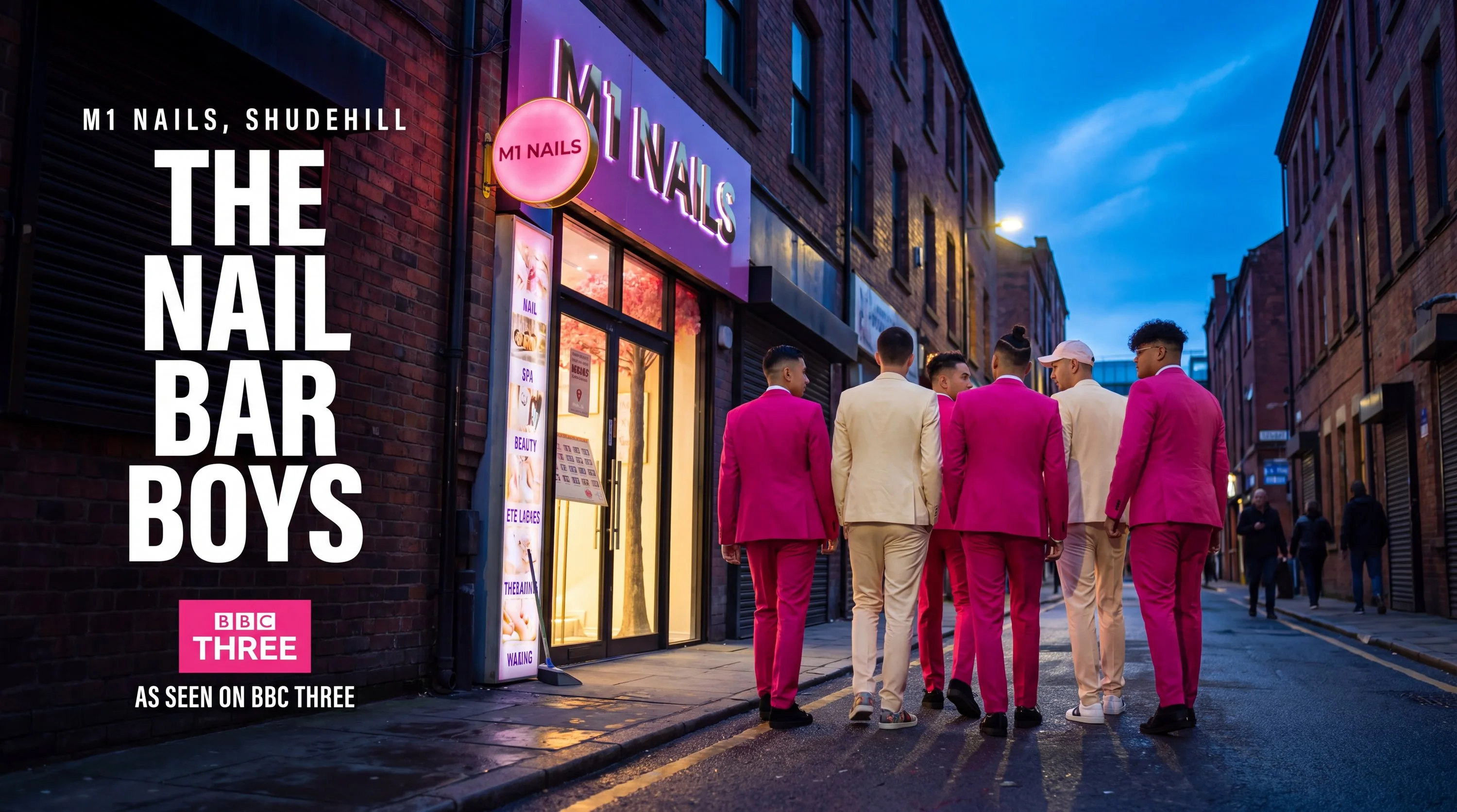 The nail bar boys in pink and cream suits walking towards the lit M1 Nails shopfront on Shudehill at dusk